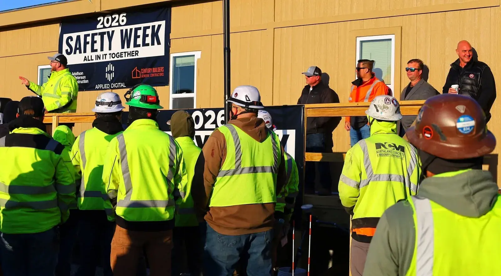 Crews at a morning stand-down on an active jobsite
